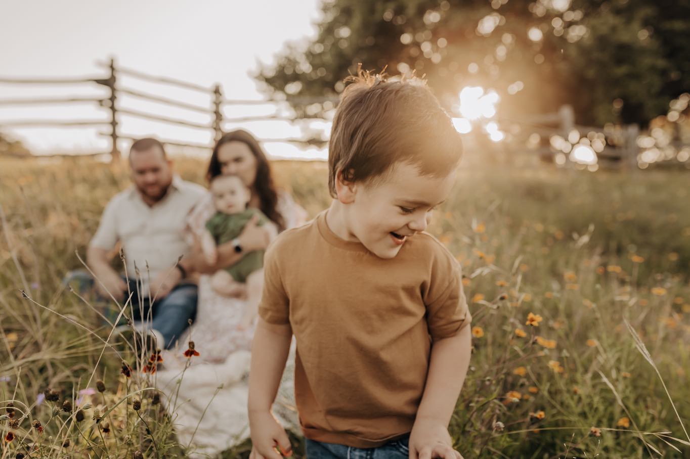Family photo session at a field during sunset by San Antonio family photographer.