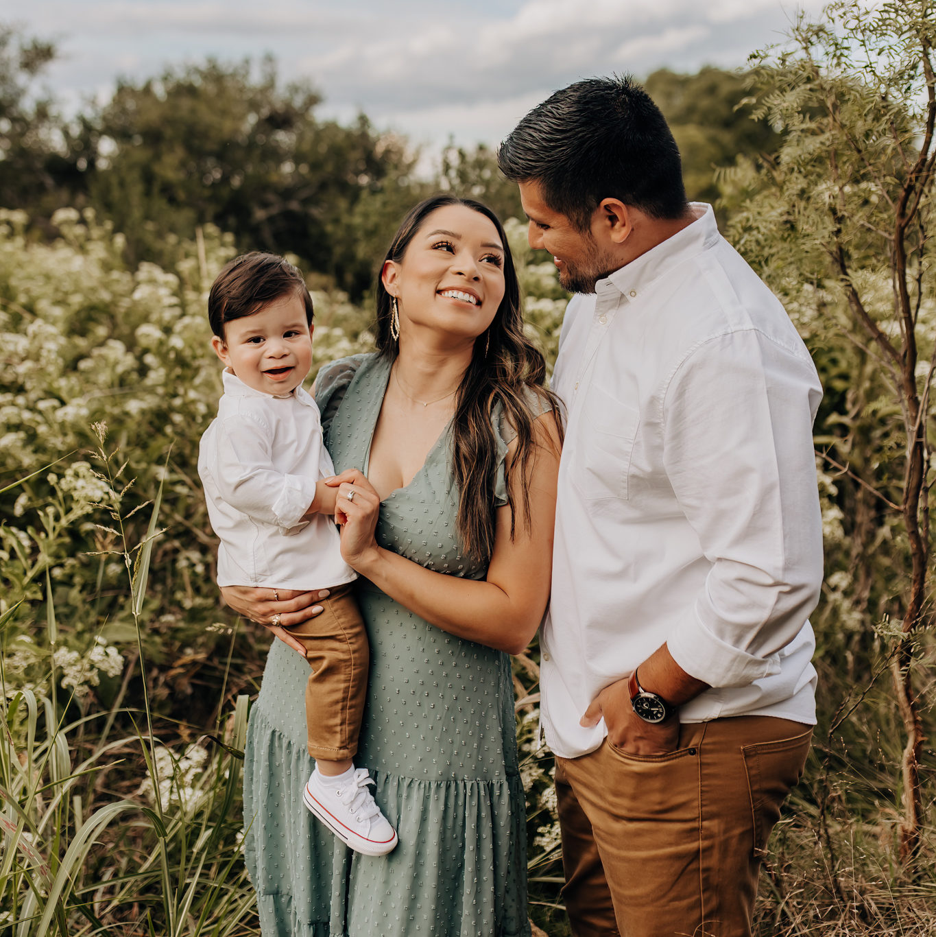 San Antonio photography spot for family photos with tall grasses, white flowers, and pretty trees.